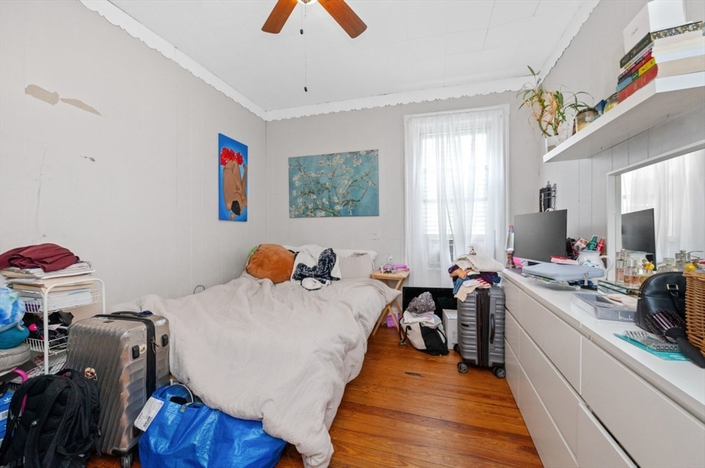 19 Dewolf Street Boston, MA 02125 - Photo 21 of 30 a bed room with a bed and a couch