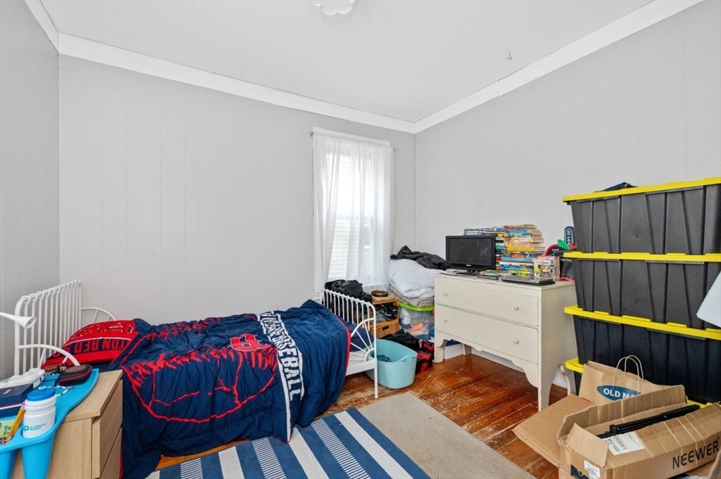 19 Dewolf Street Boston, MA 02125 - Photo 22 of 30 a bedroom with furniture and a window