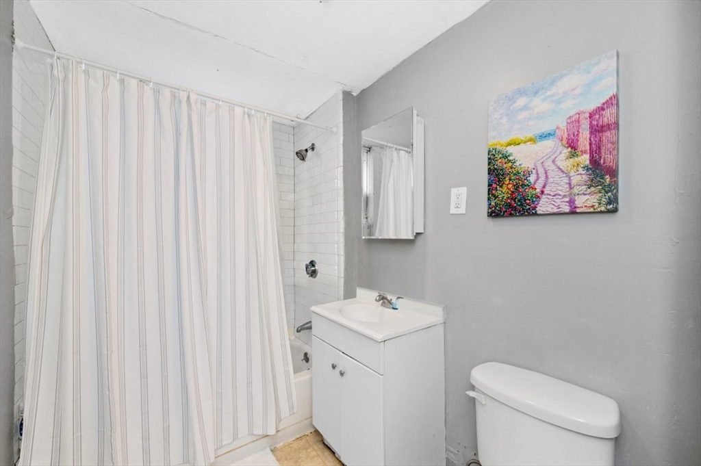 19 Dewolf Street Boston, MA 02125 - Photo 23 of 30 a bathroom with a toilet sink and vanity