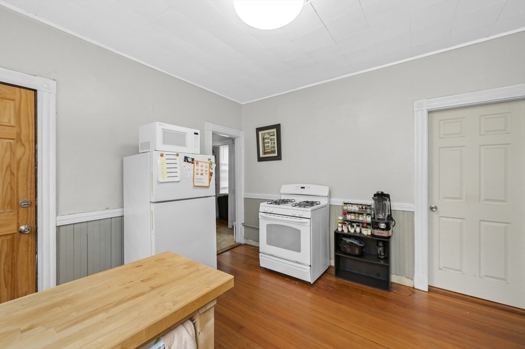 19 Dewolf Street Boston, MA 02125 - Photo 5 of 30 a kitchen with stainless steel appliances a refrigerator and wooden floor