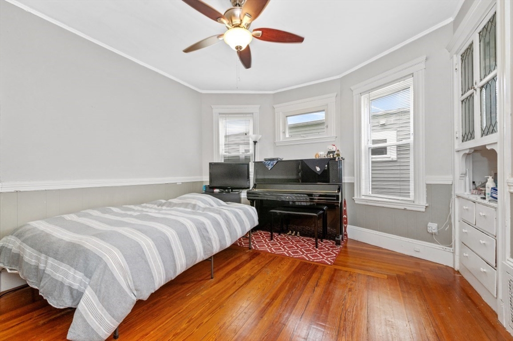19 Dewolf Street Boston, MA 02125 - Photo 6 of 30 a bedroom with a bed and wooden floor