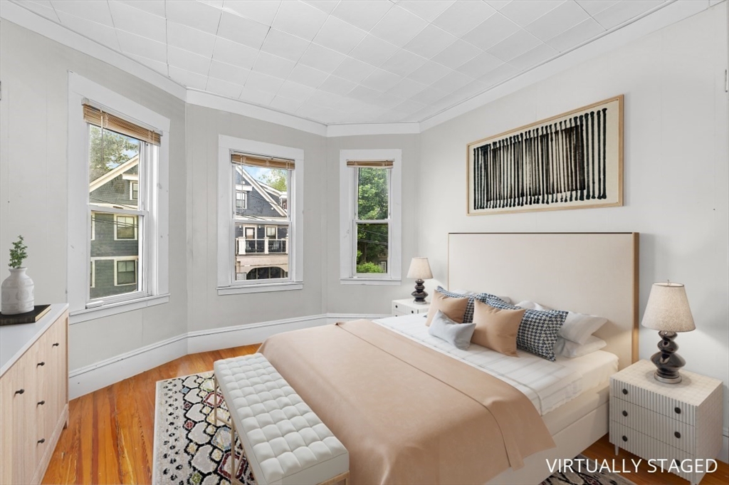 19 Dewolf Street Boston, MA 02125 - Photo 9 of 30 a bedroom with a bed and a window