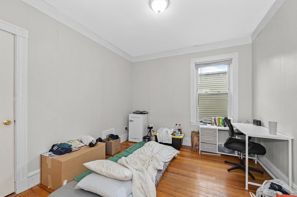 19 Dewolf Street Boston, MA 02125 - Photo 10 of 30 a bedroom with furniture and a wooden floor