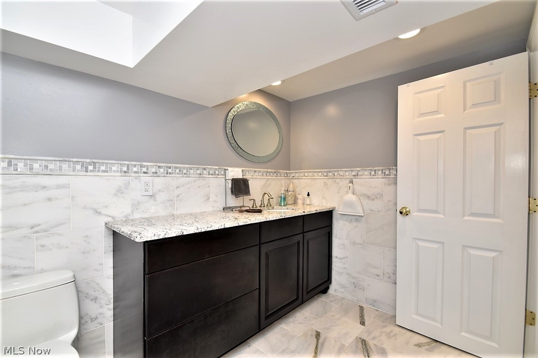 8790 Avery Road Broadview Heights, OH 44147 - Photo 29 of 35 Marble extends throughout the floor and up the walls, giving this lower level bath a bright, luxurious feel.