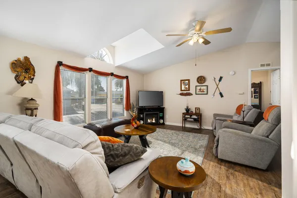 a living room with furniture a fireplace and a flat screen tv