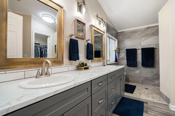 a bathroom with a double vanity sink and a large mirror