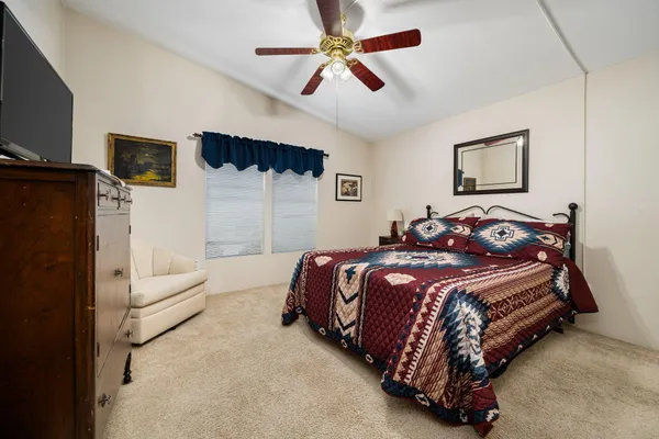 a bedroom with bed and a flat screen tv