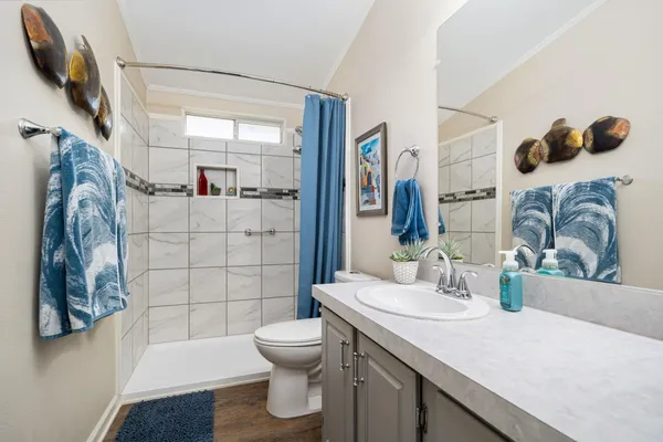 a bathroom with a sink toilet and shower