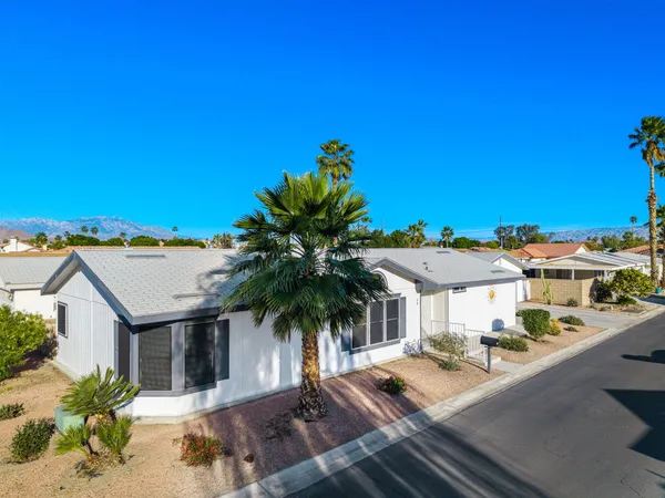 a view of a house with pool and sitting area