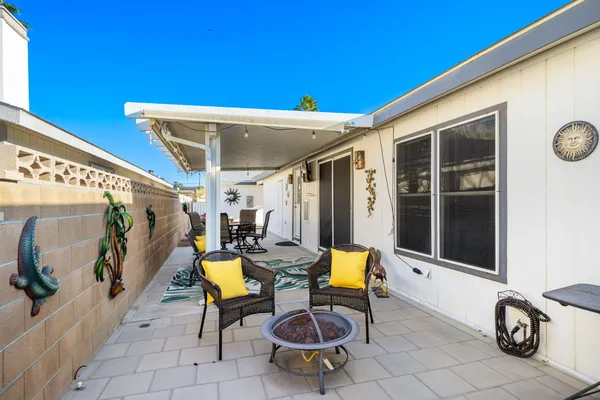 a view of a patio with table and chairs and potted plants