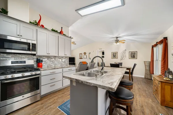 a kitchen with a stove a sink and a refrigerator