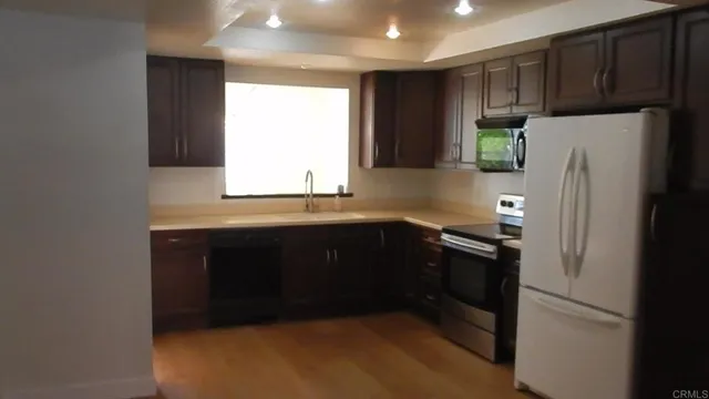 a kitchen with a refrigerator and a sink