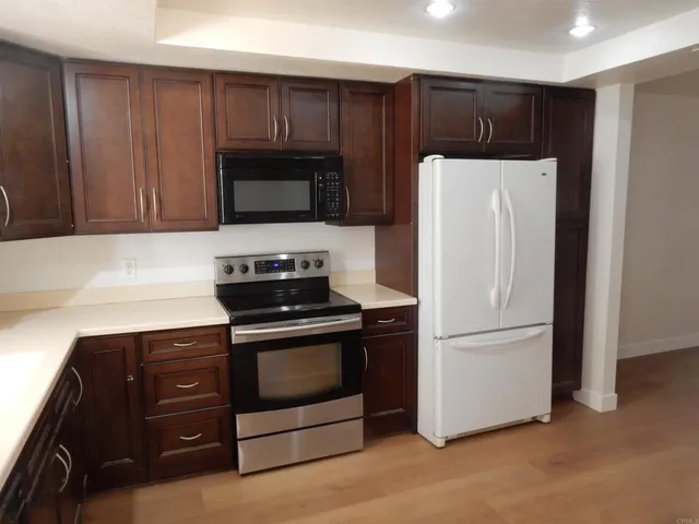 a kitchen with a refrigerator stove and microwave