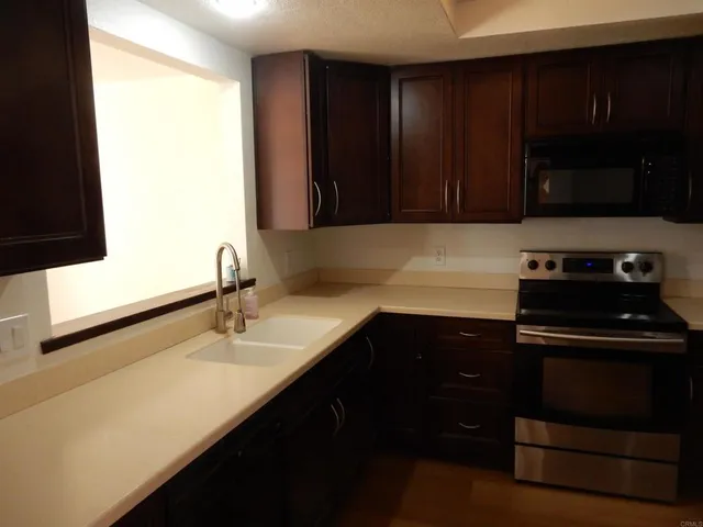 a kitchen with a sink and a stove top oven