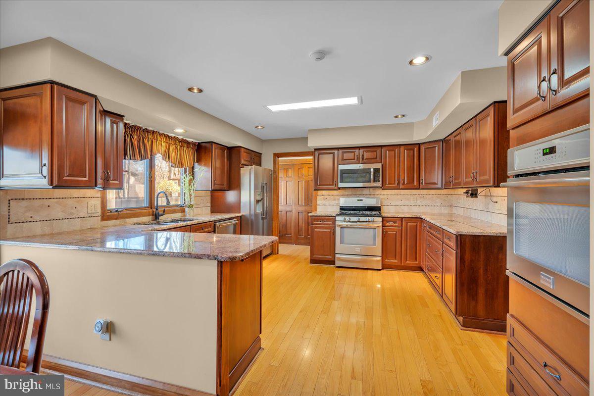 6 Edelweiss Lane Voorhees, NJ 08043 - Photo 11 of 46 a kitchen with stainless steel appliances granite countertop wooden cabinets a sink dishwasher a stove and a refrigerator