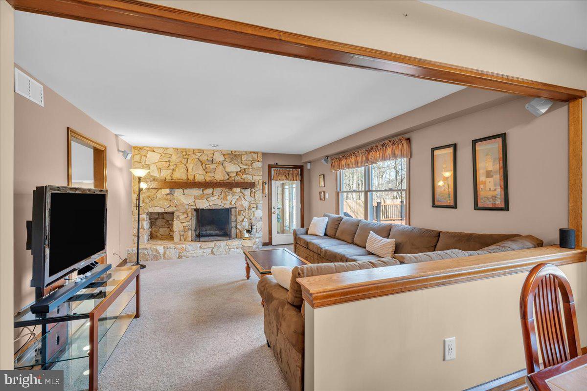 6 Edelweiss Lane Voorhees, NJ 08043 - Photo 14 of 46 a living room with furniture a flat screen tv and a floor to ceiling window