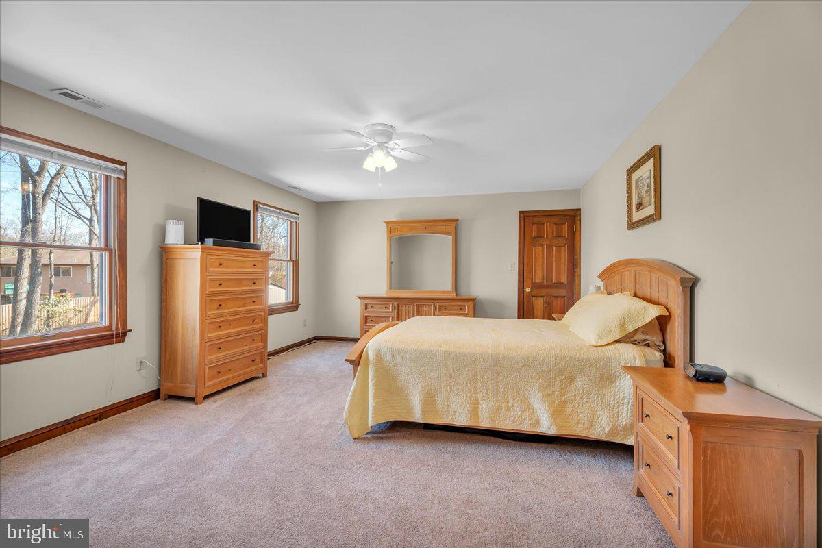 6 Edelweiss Lane Voorhees, NJ 08043 - Photo 25 of 46 a spacious bedroom with a bed and a chandelier