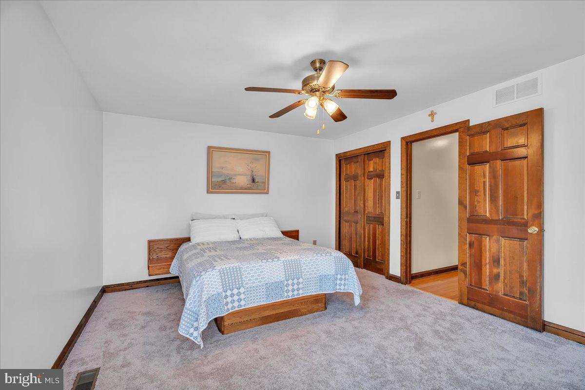 6 Edelweiss Lane Voorhees, NJ 08043 - Photo 28 of 46 a bedroom with a bed and a chandelier