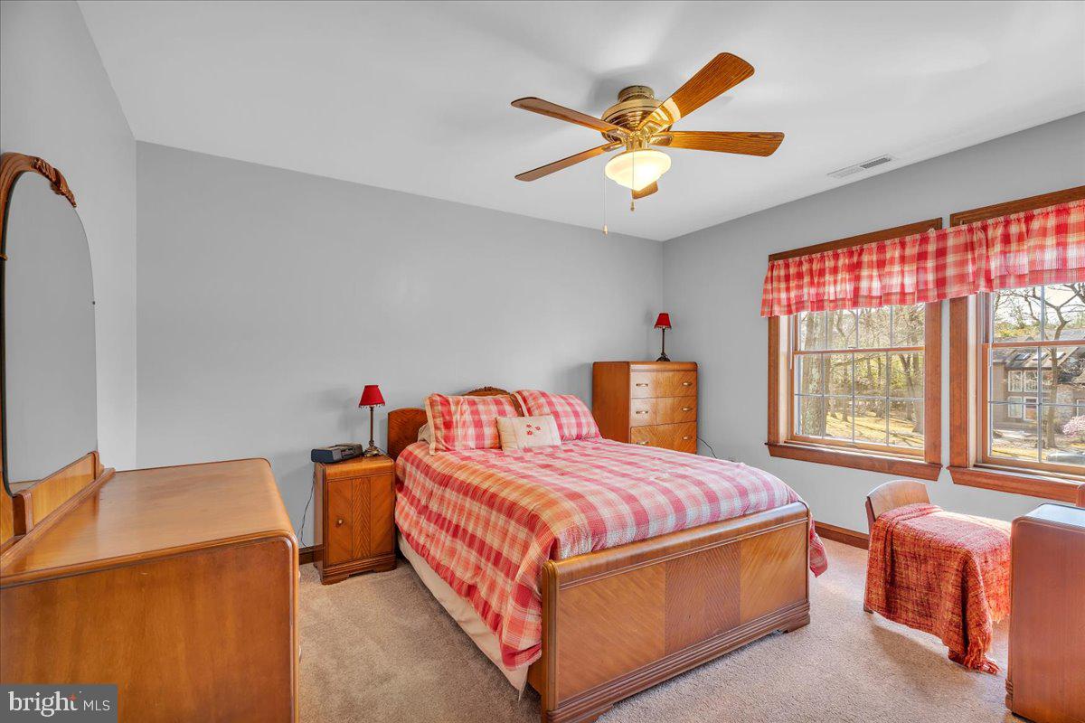 6 Edelweiss Lane Voorhees, NJ 08043 - Photo 30 of 46 a bedroom with a bed and a chandelier