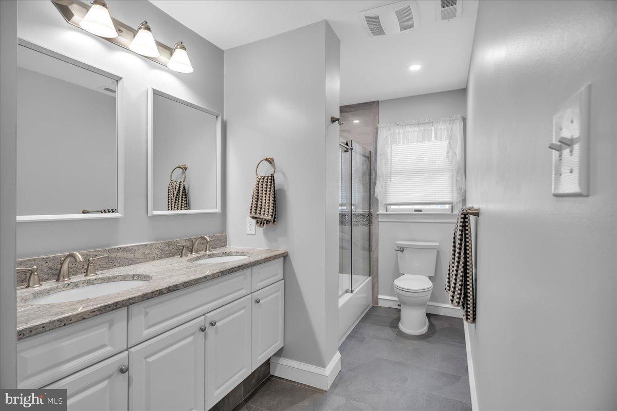 6 Edelweiss Lane Voorhees, NJ 08043 - Photo 31 of 46 a bathroom with a toilet a sink a light fixture and a mirror