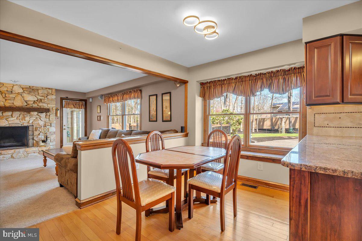 6 Edelweiss Lane Voorhees, NJ 08043 - Photo 10 of 46 a dining room with furniture a fireplace and wooden floor