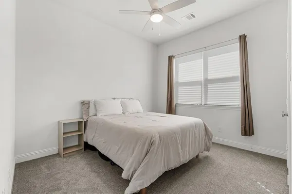 a bedroom with a bed and window