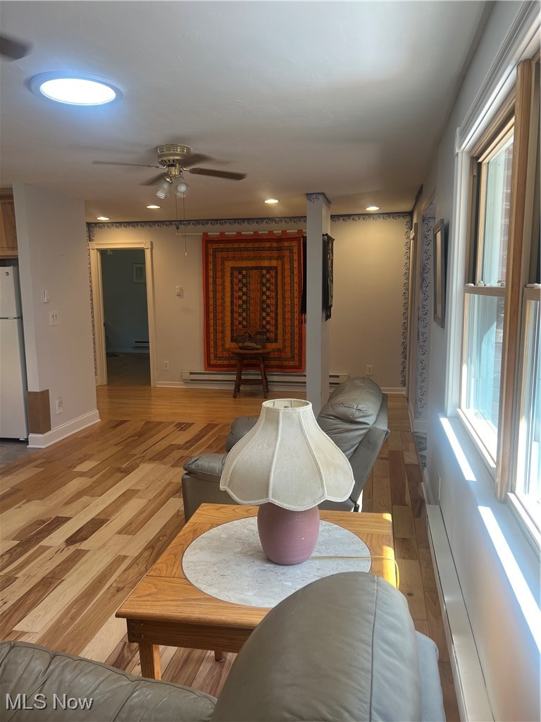 6171 Barrett Road Geneva, OH 44041 - Photo 20 of 38 Living room with light wood-style flooring, baseboard heating, a ceiling fan, and recessed lighting