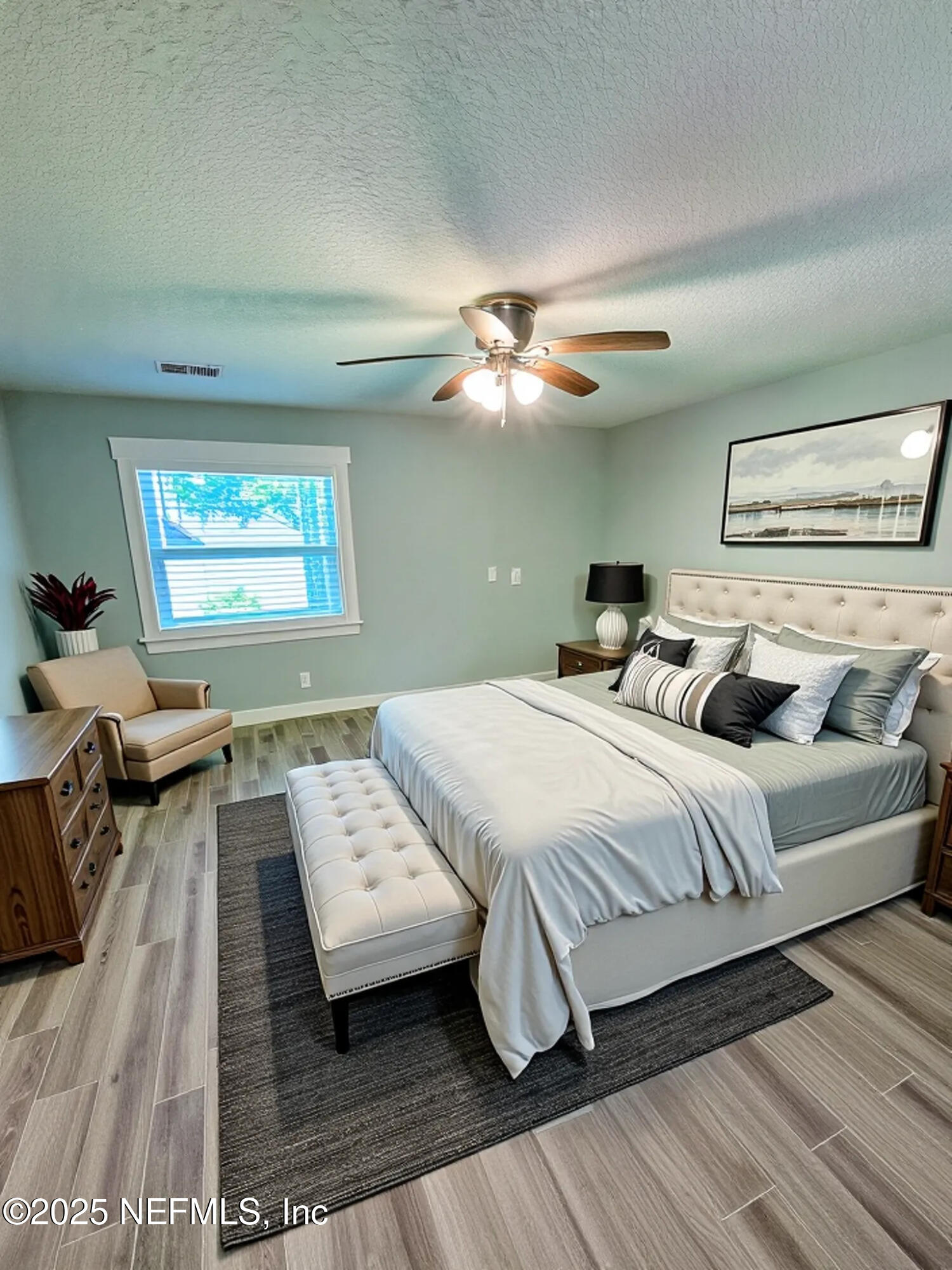 7701 Timberlin Park Boulevard, Unit 322 Jacksonville, FL 32256 - Photo 15 of 31 a bedroom with a large bed mirror and a window