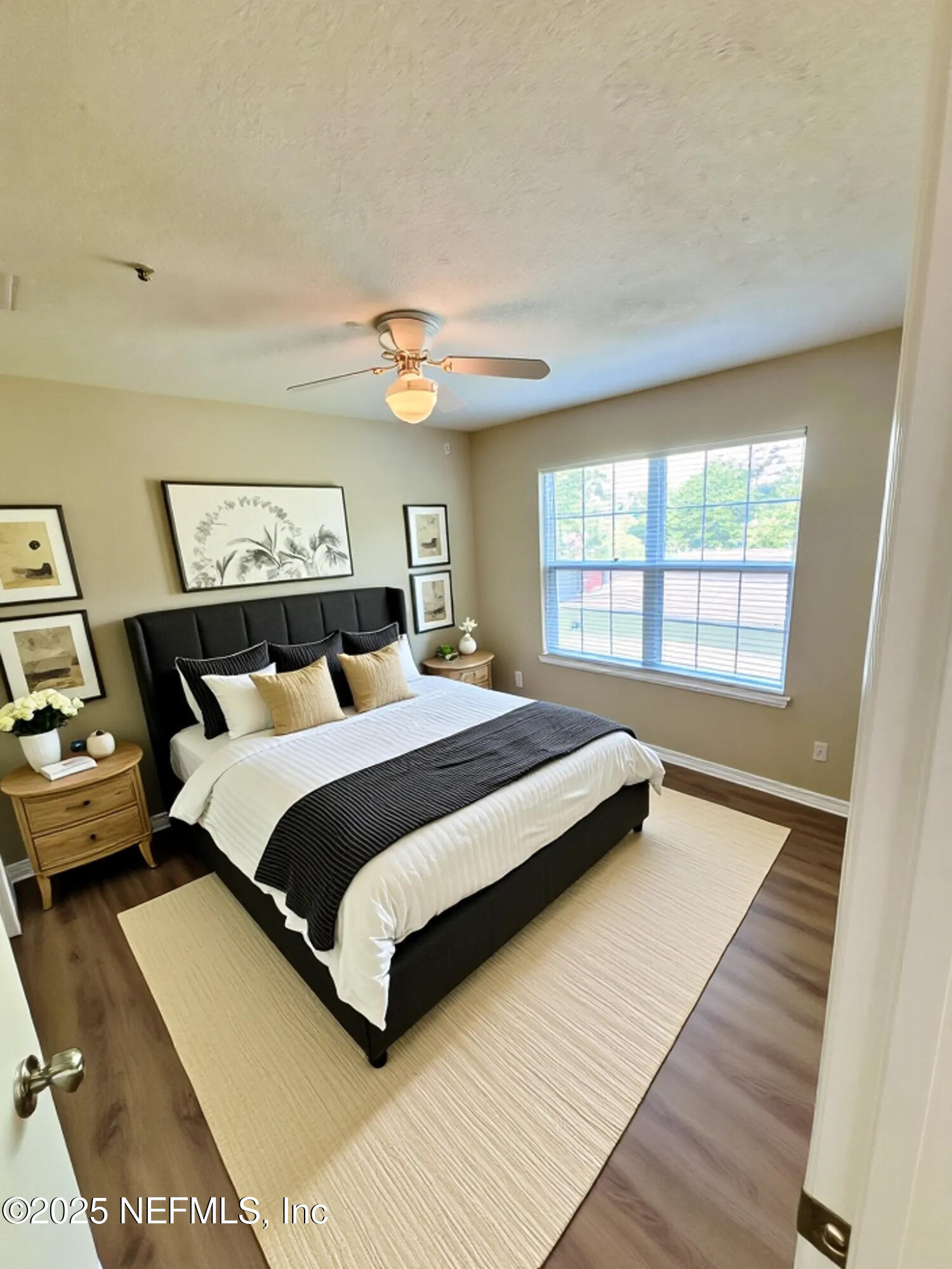 7701 Timberlin Park Boulevard, Unit 322 Jacksonville, FL 32256 - Photo 23 of 31 a bedroom with a bed and a large window