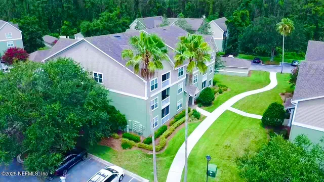 an aerial view of an house with swimming pool and garden