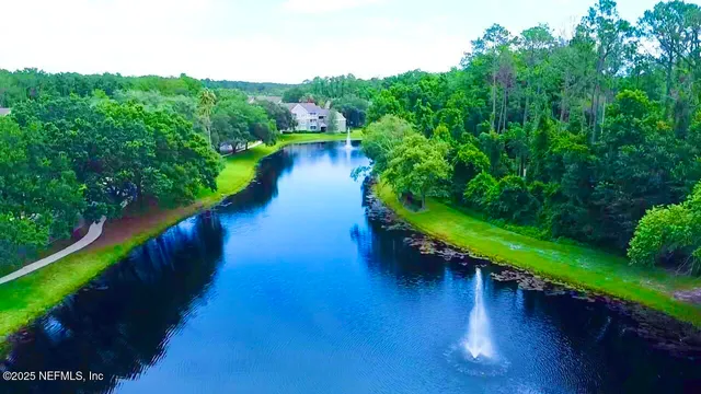 a view of a lake with a floor to ceiling yard