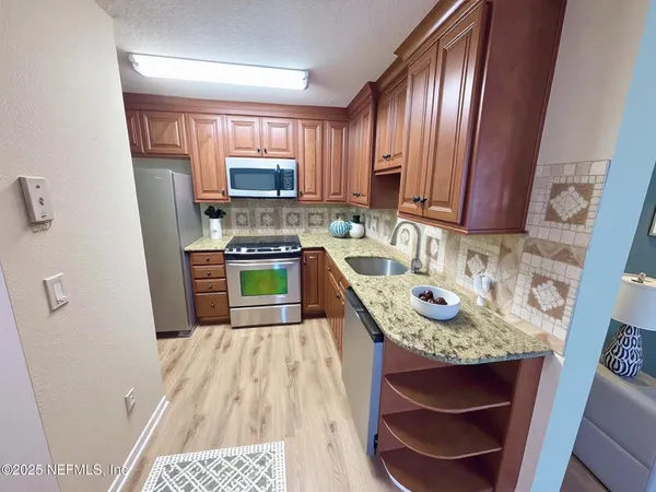a kitchen with a sink stove and refrigerator