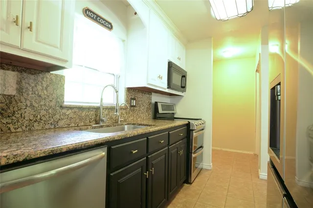 a kitchen with a sink and a refrigerator