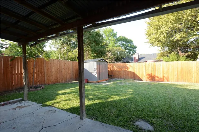 a view of a backyard with large trees