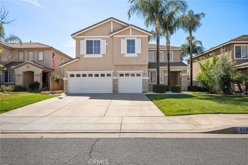 a front view of a house with a yard and garage