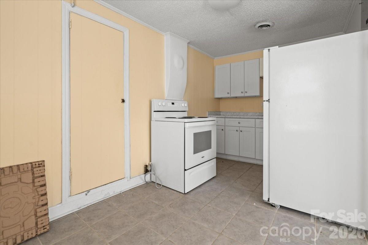 501 Church Street Cheraw, SC 29520 - Photo 21 of 48 a view of a kitchen with white cabinets and white appliances