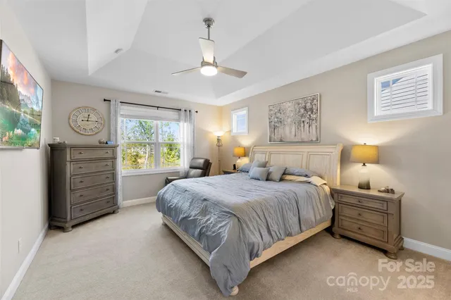 a bedroom with a bed dresser and a window