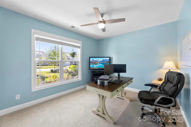 a work room with furniture and a window