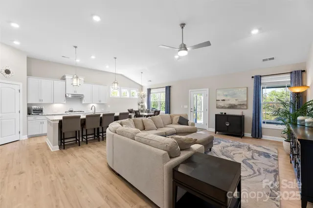 a living room with furniture fireplace and a table