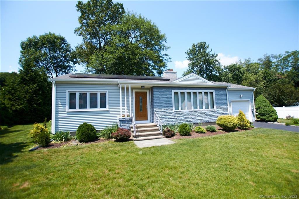 a front view of a house with a garden