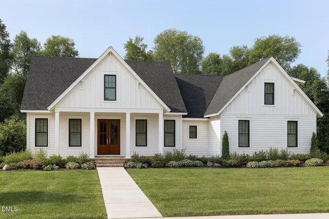 a view of a white house with a yard