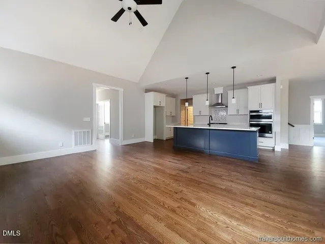 a view of a kitchen with cabinets and wooden floor