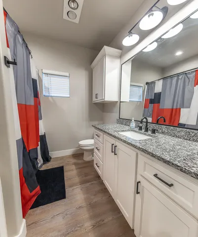 a kitchen with granite countertop lots of clutter and stainless steel appliances