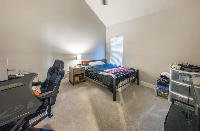 a bedroom with a bed and a chair