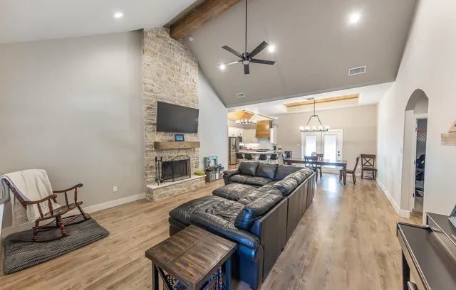 a living room with fireplace furniture and a flat screen tv