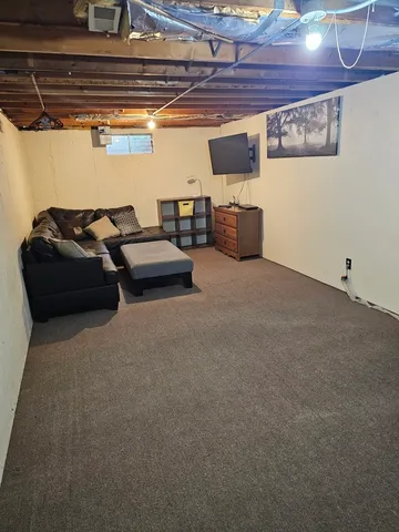 a living room with lots of furniture and clutter