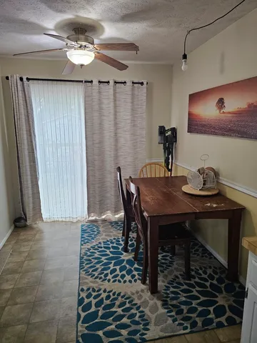 a view of a dining room with furniture and chandelier