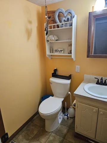 a white toilet sitting next to a bathroom sink