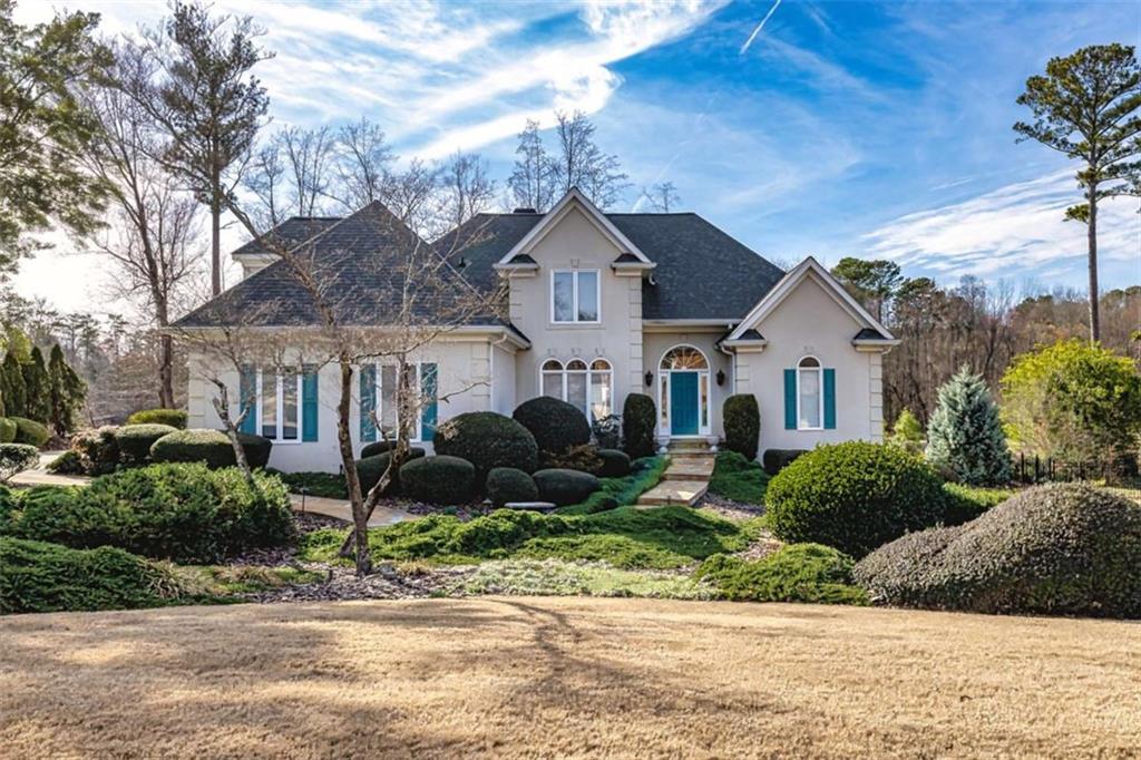 a front view of a house with garden
