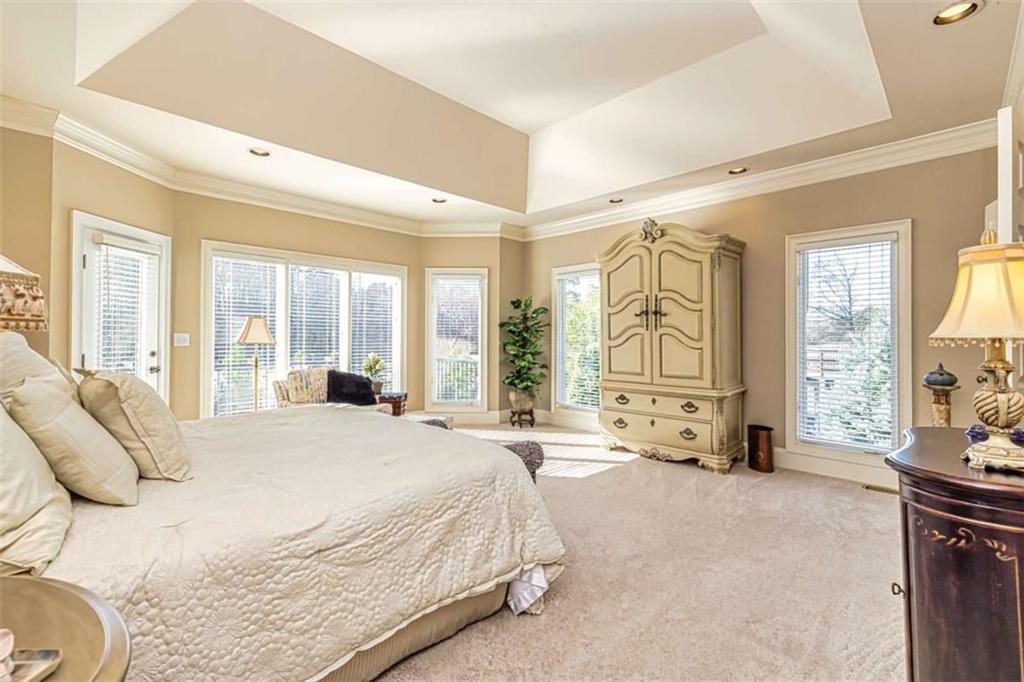 35 Torrey Pines Court Newnan, GA 30265 - Photo 15 of 54 a spacious bedroom with a bed and large windows